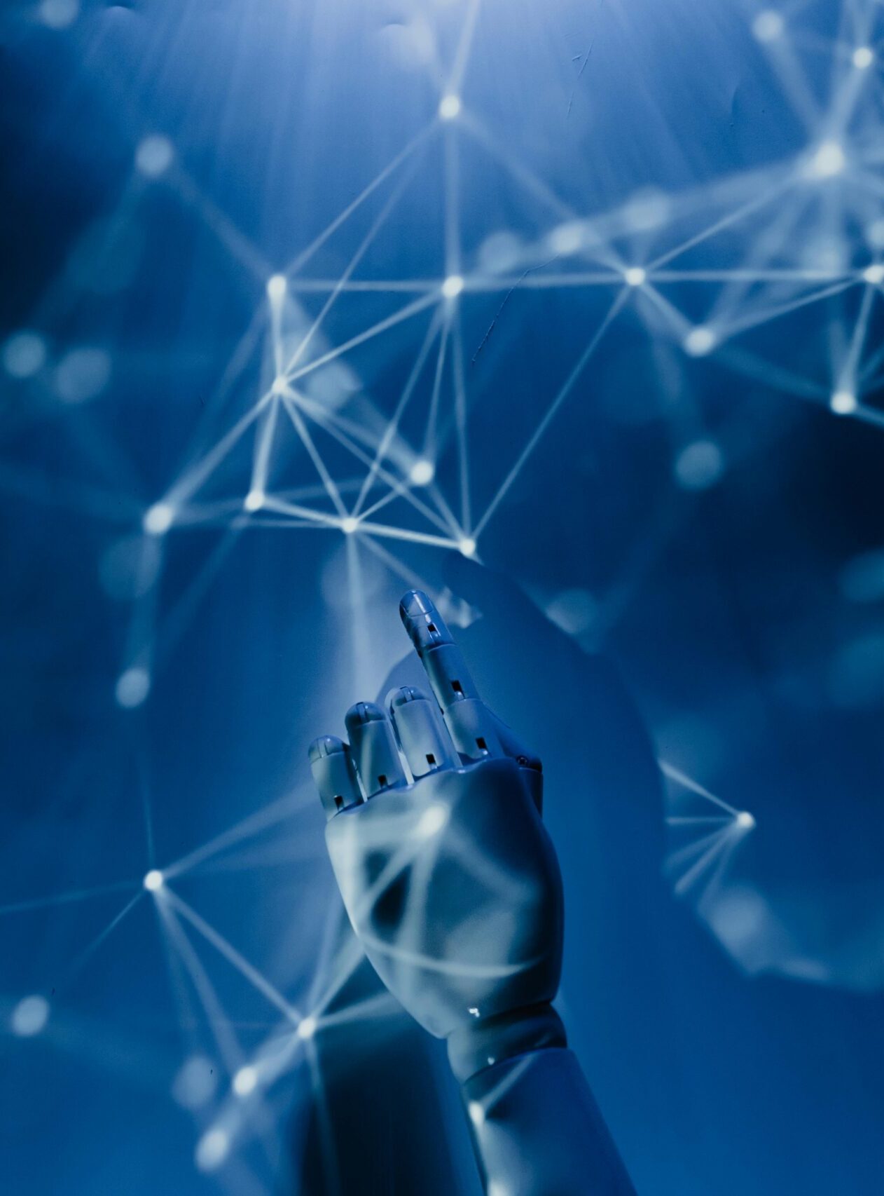 A robotic hand reaching into a digital network on a blue background, symbolizing AI technology.